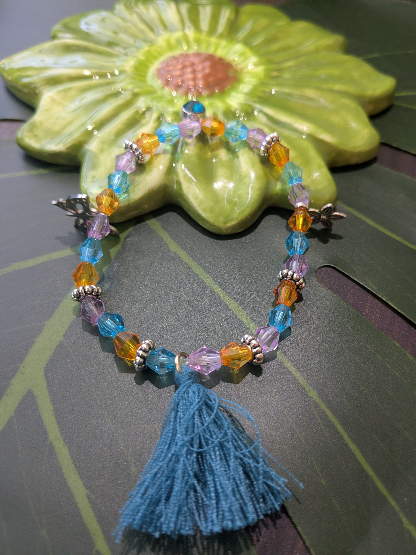 Beaded bracelet with tassel and charms