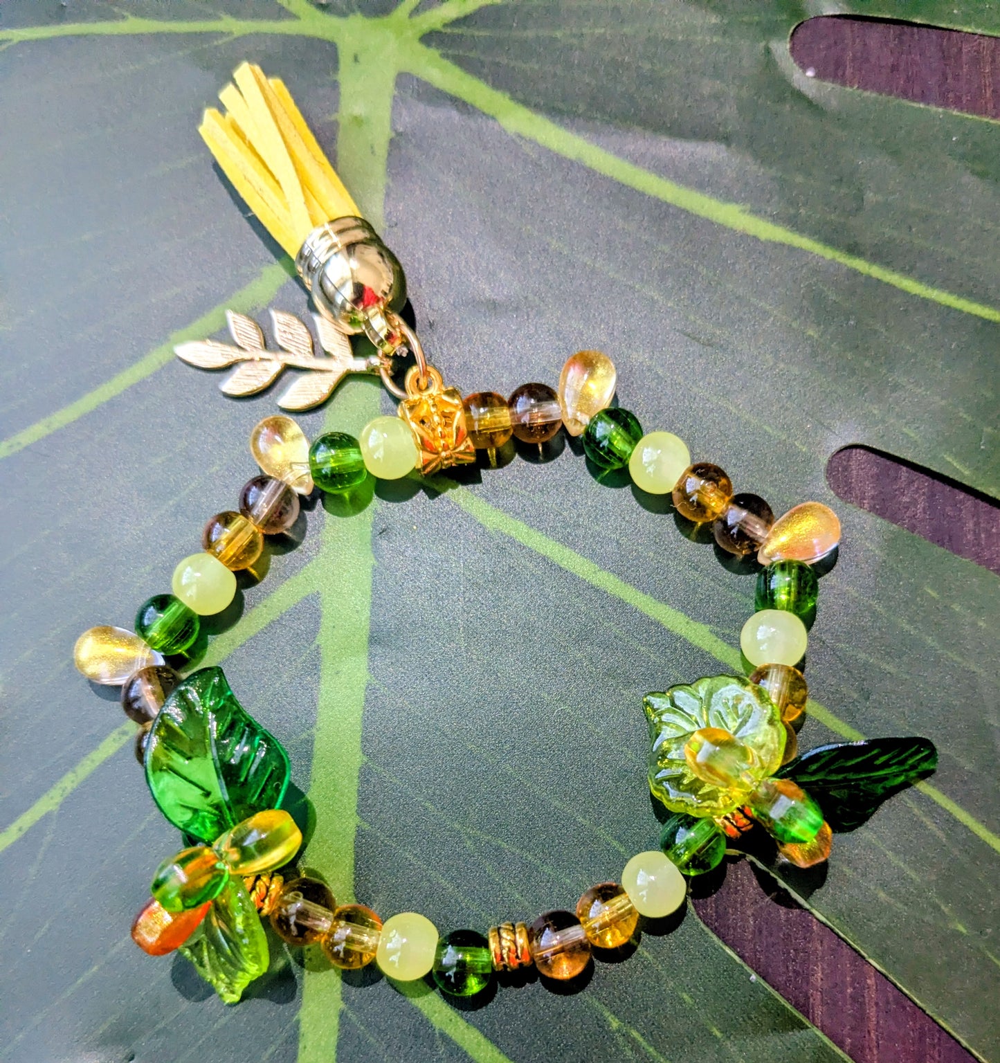 Beaded bracelet with charm and tassel