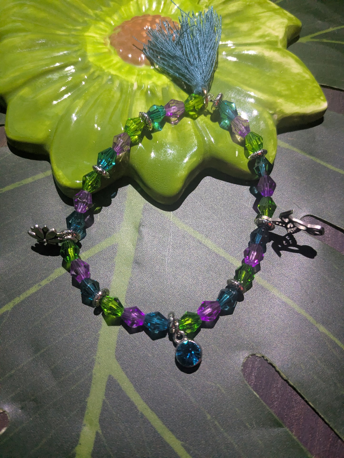 Beaded bracelet with charms and tassel