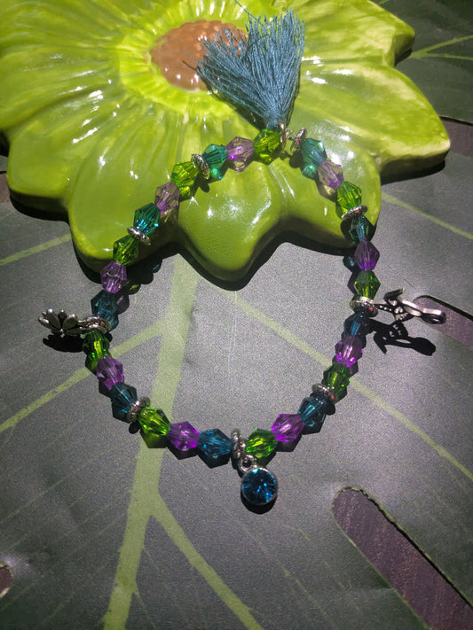 Beaded bracelet with charms and tassel