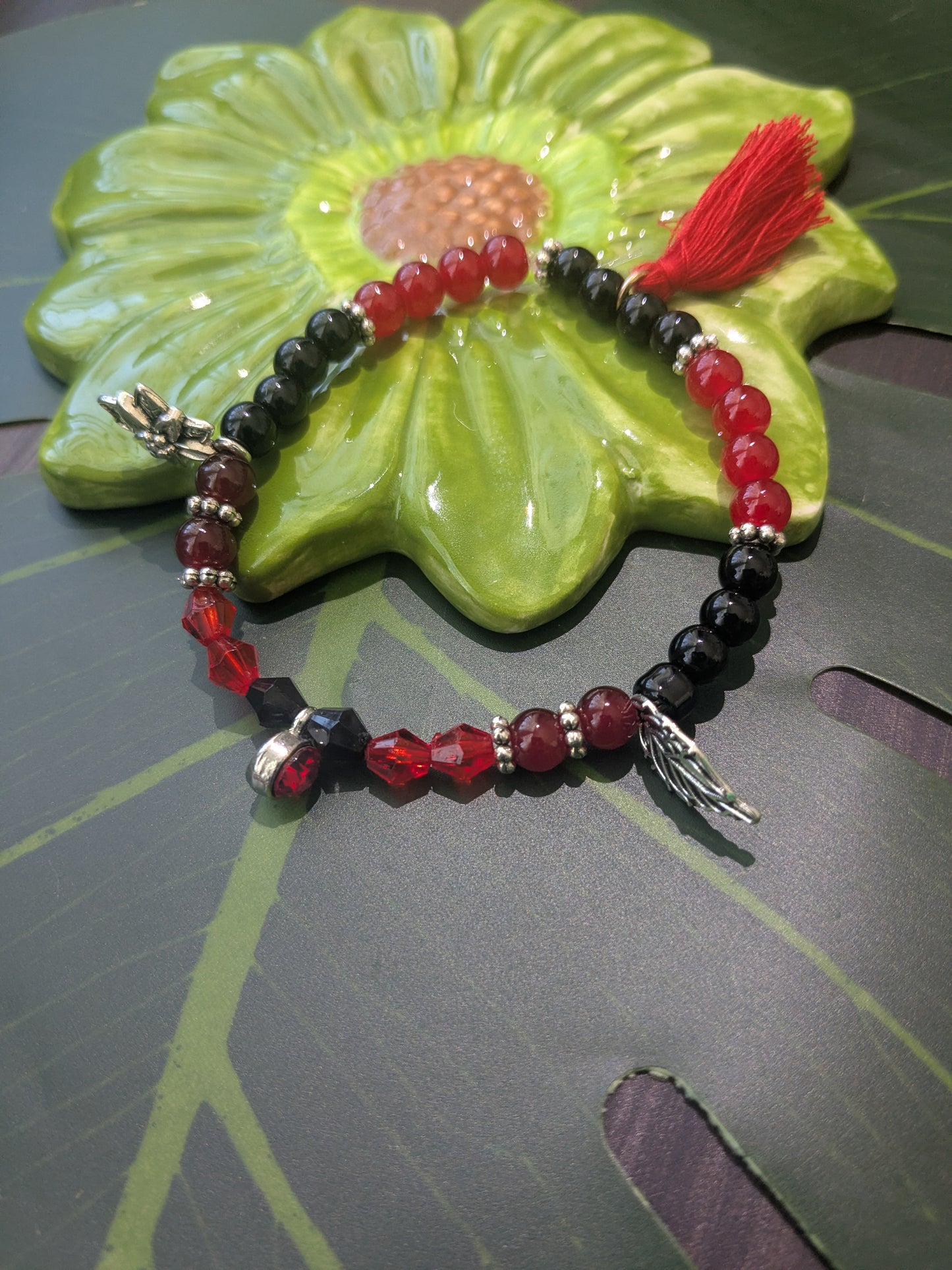 Beaded bracelet with tassel an charms