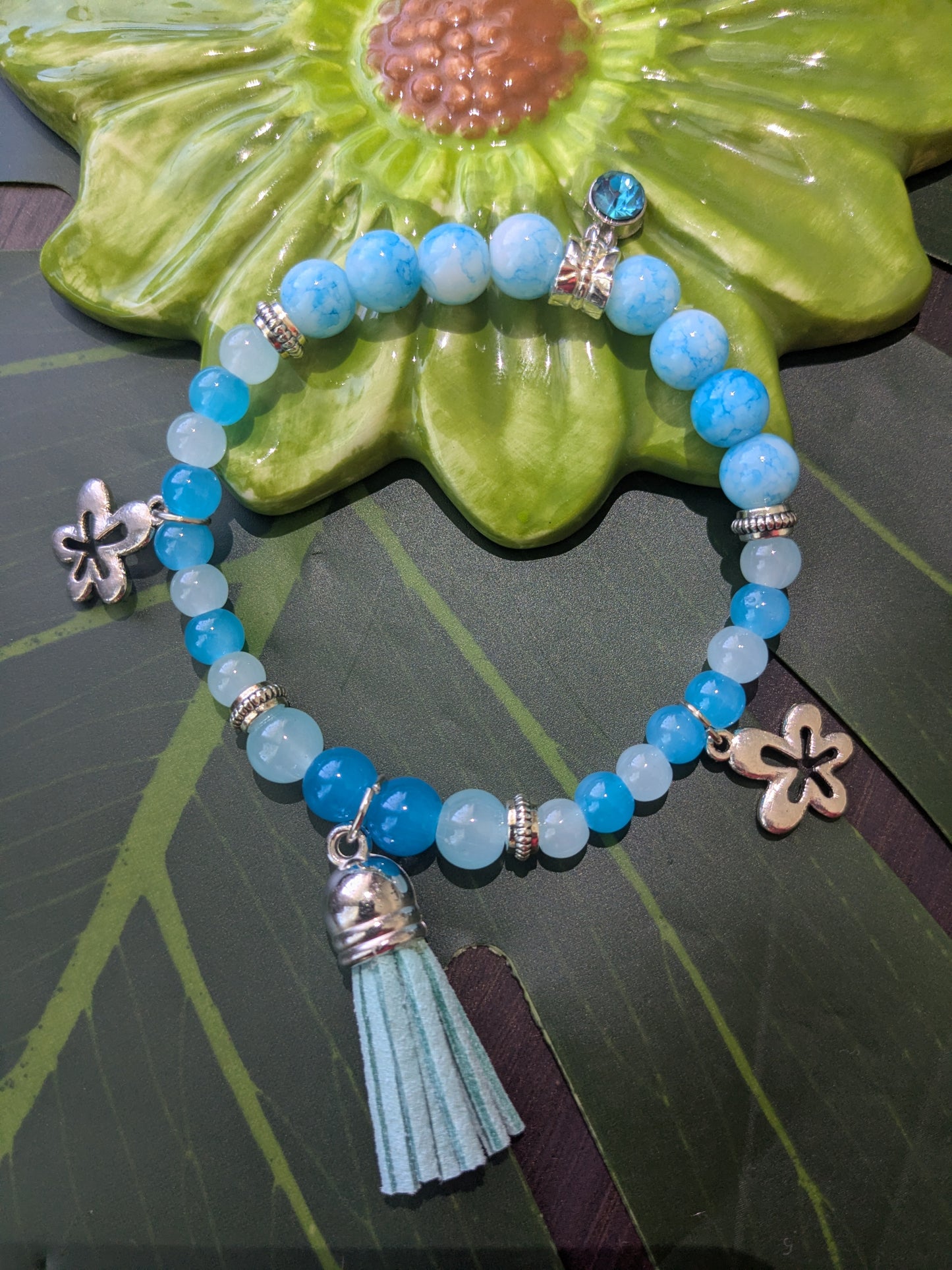 Beaded bracelet with charms, tassel and birth stone