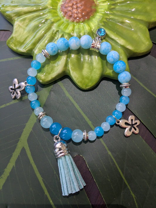Beaded bracelet with charms, tassel and birth stone