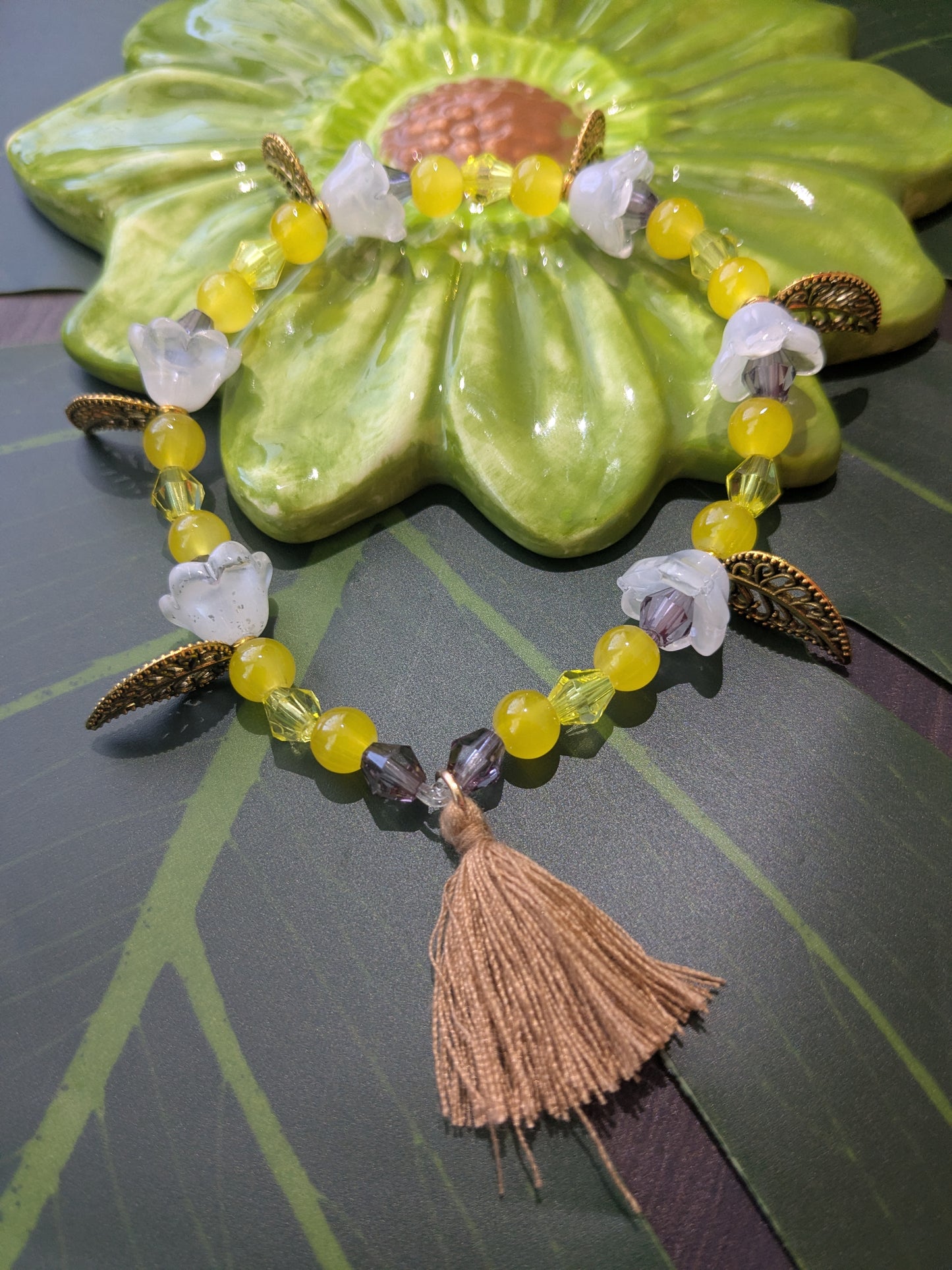 Beaded bracelet with charms and tassel
