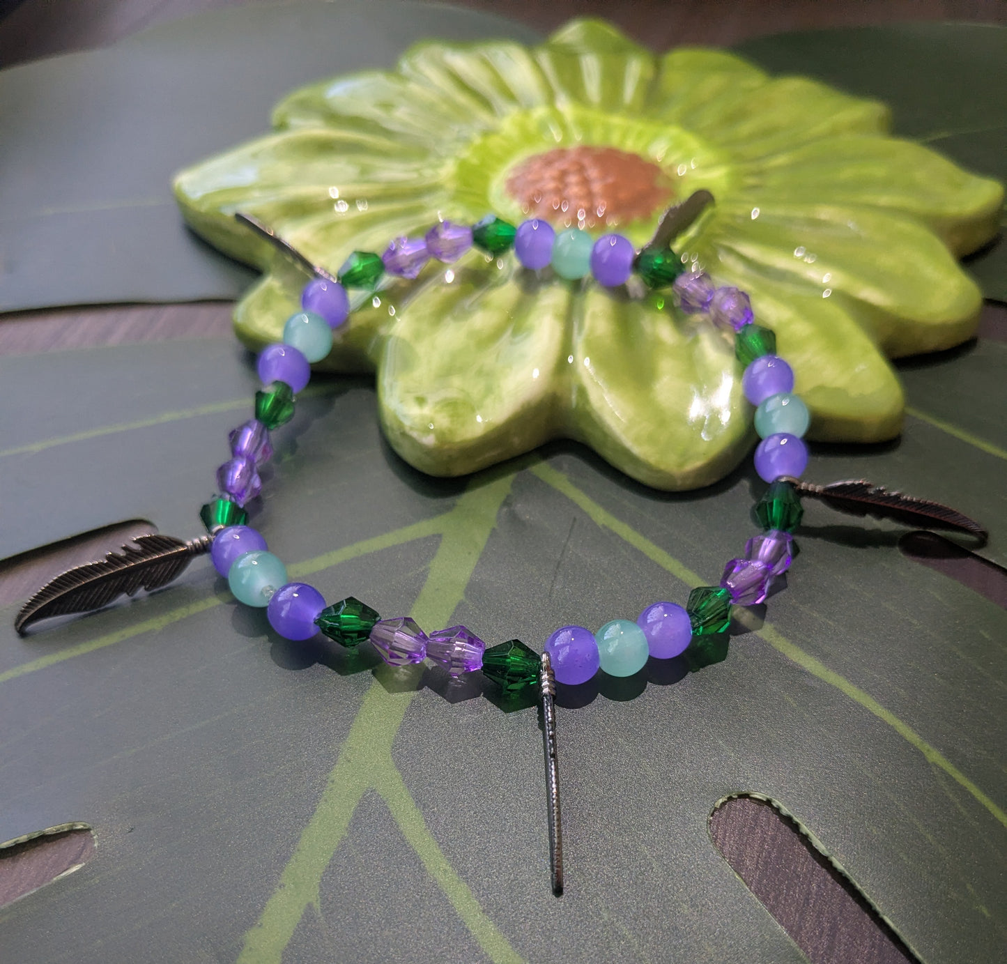 Beaded bracelet with feather charms