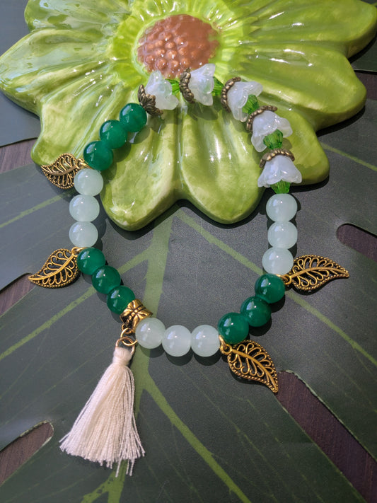 Beaded bracelet with tassel and charms