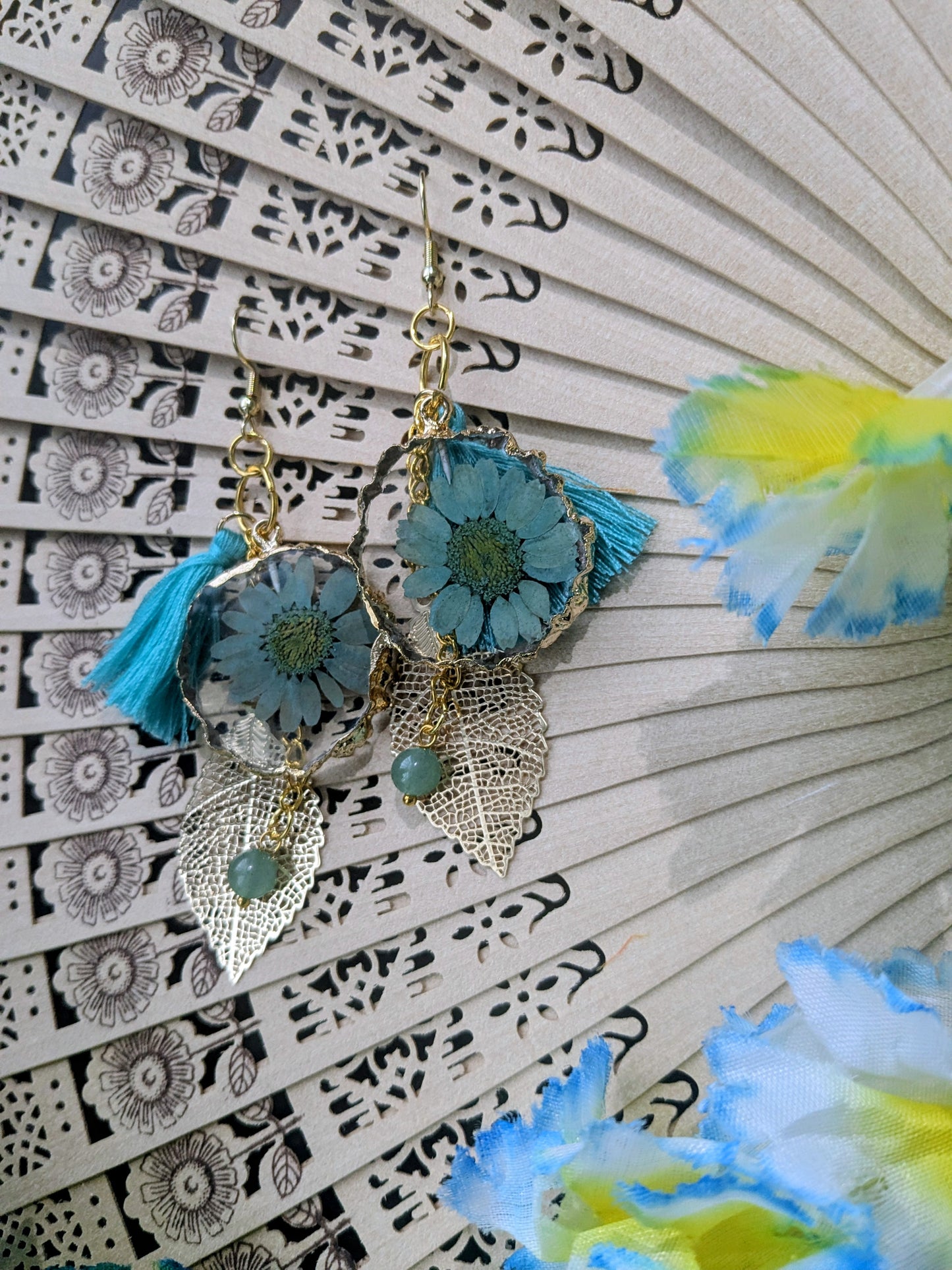 Earrings with dangling charms and tassel