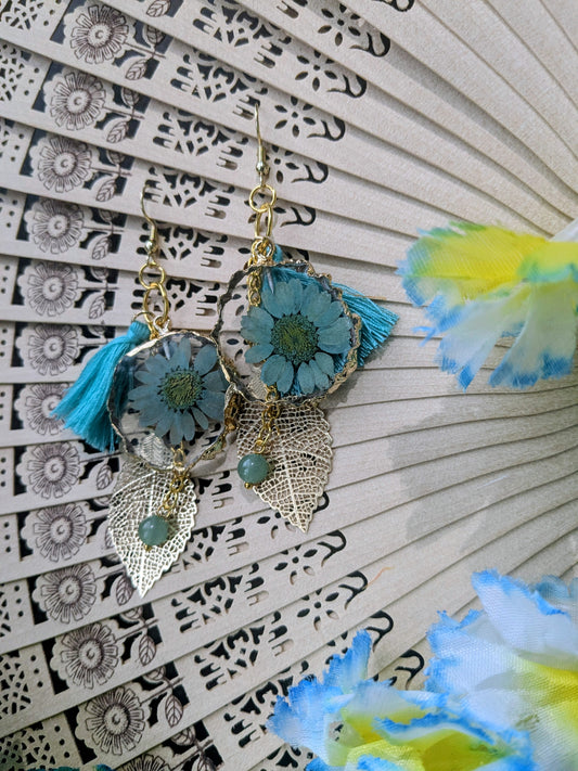 Earrings with dangling charms and tassel