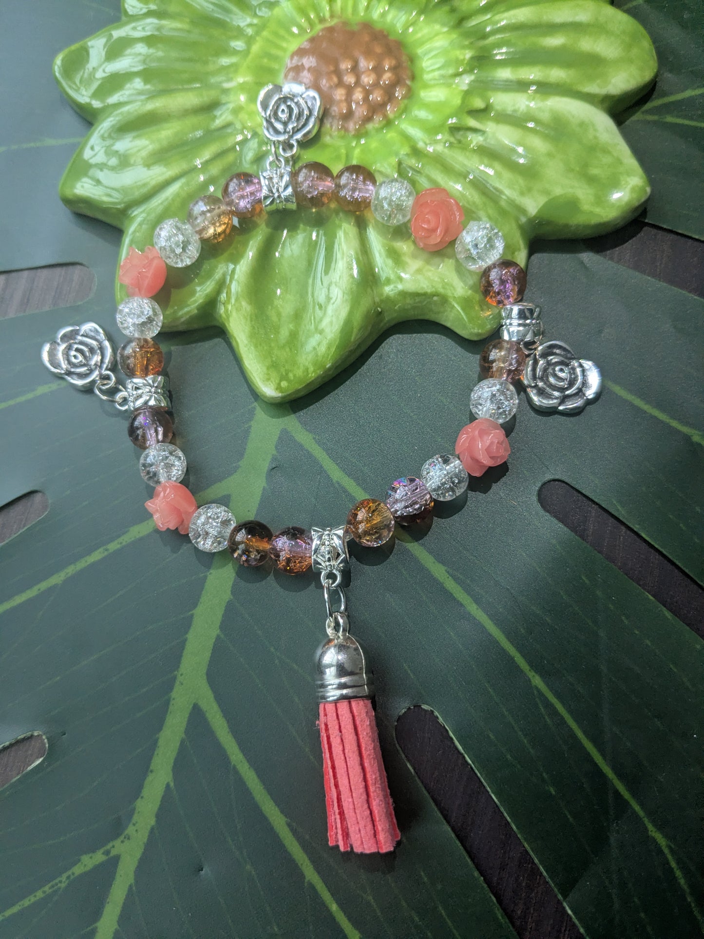Beaded bracelet with charms and tassel