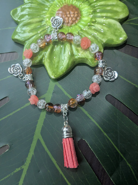 Beaded bracelet with charms and tassel