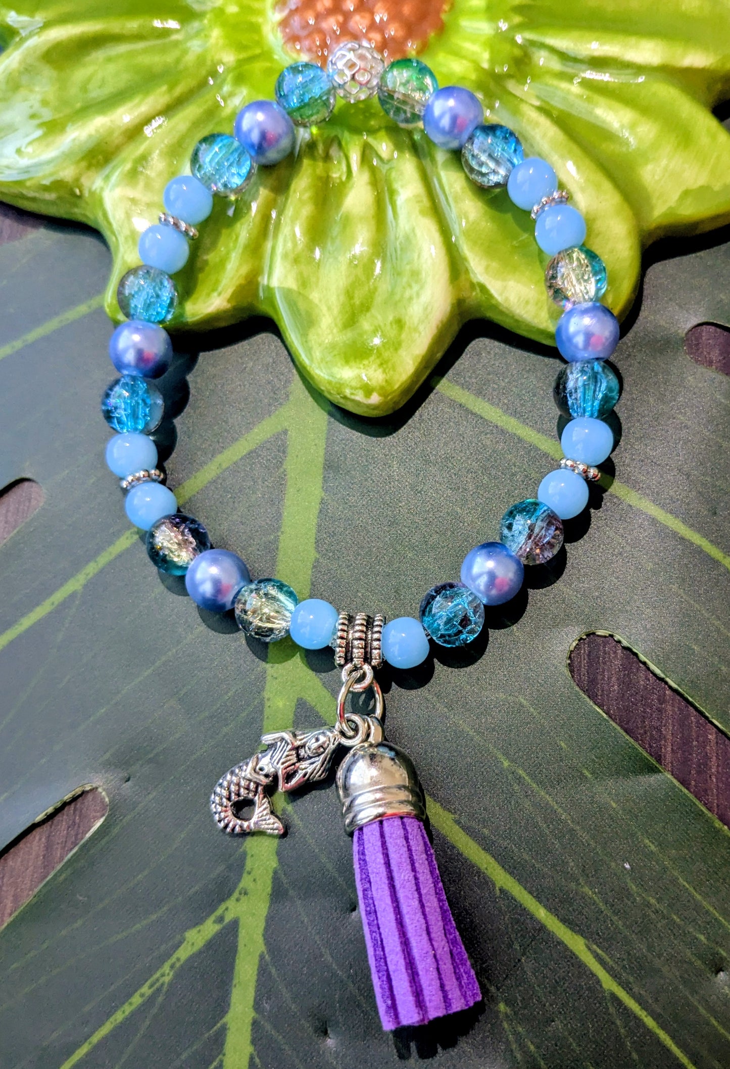 Beaded bracelet with charm and tassel
