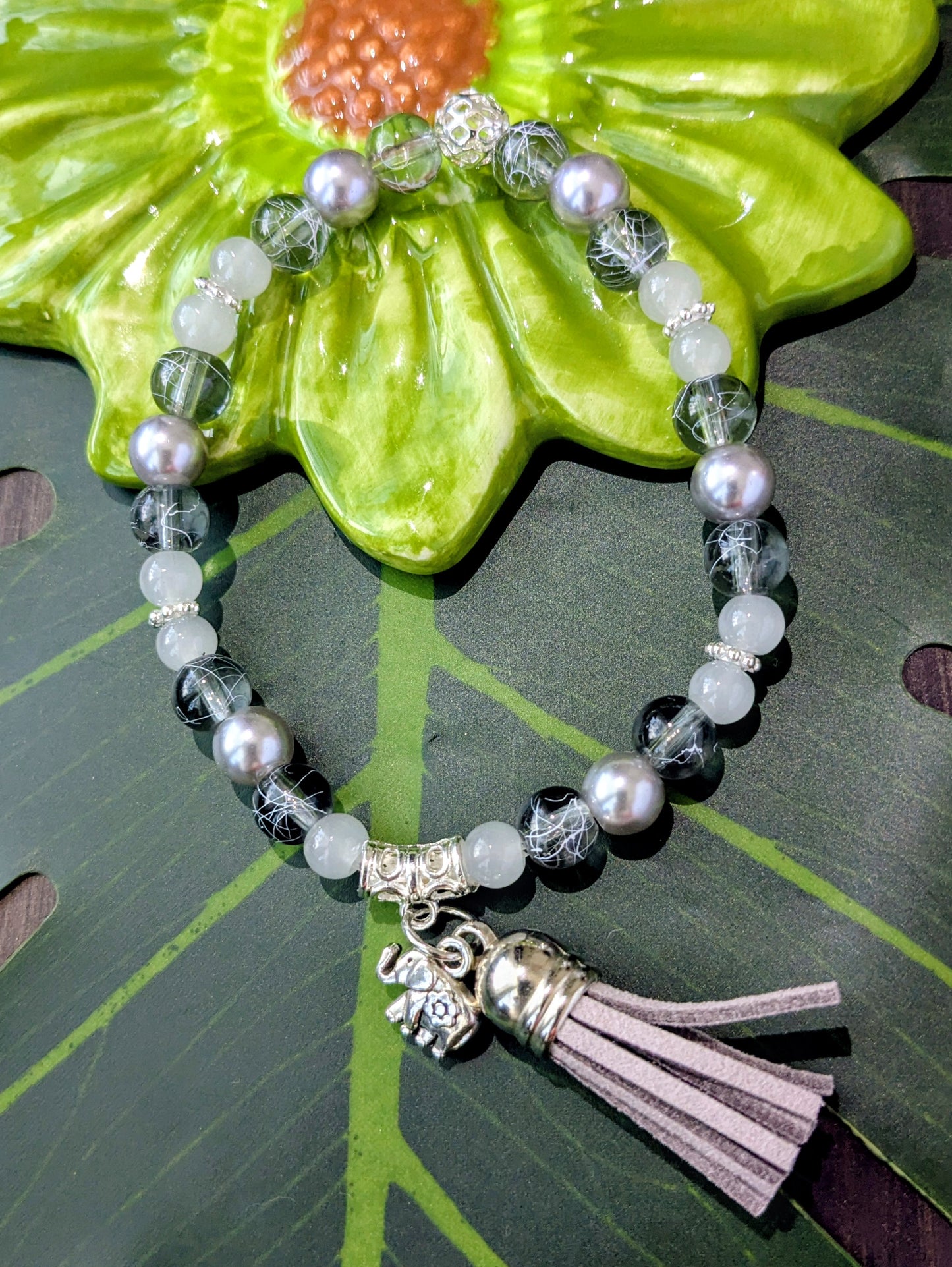 Beaded bracelet with charm and tassel
