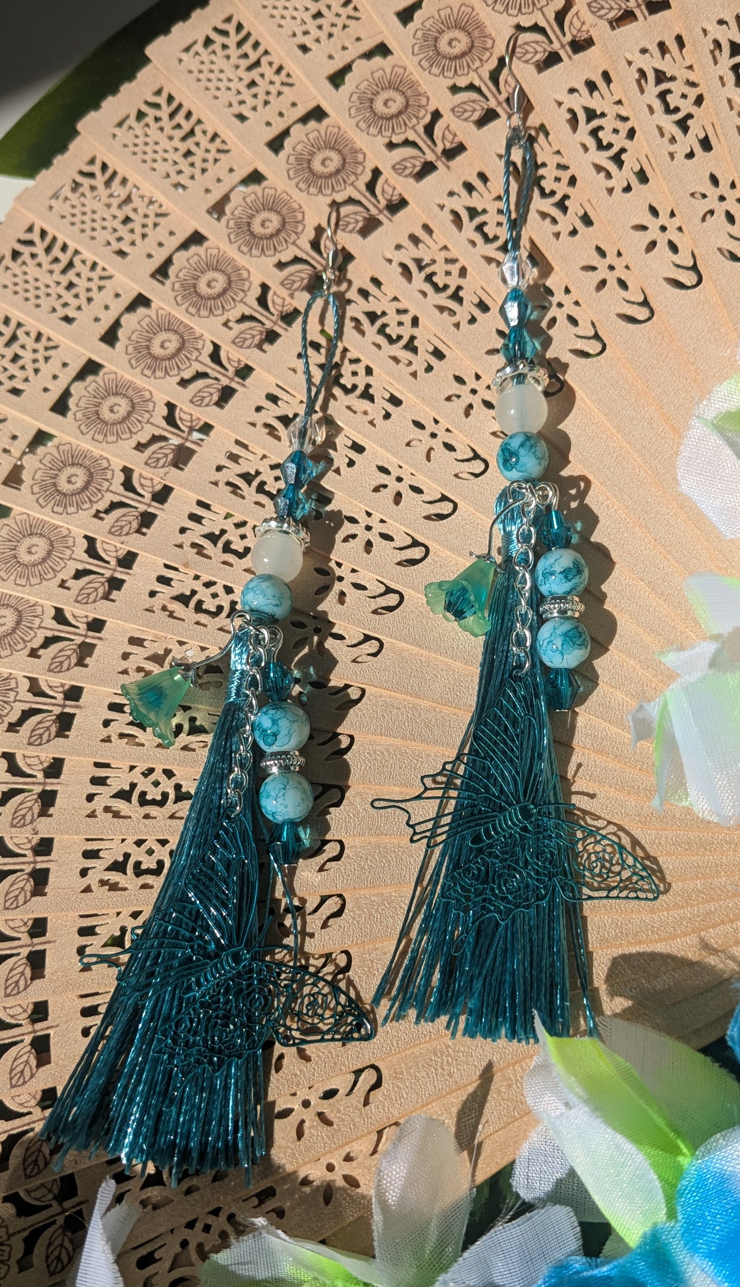 Earring with tassel, beads, and flower